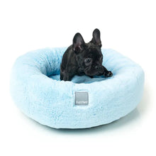 Load image into Gallery viewer, Dog relaxing in a blue FuzzYard Dreameazzzy Cuddler Dog Bed