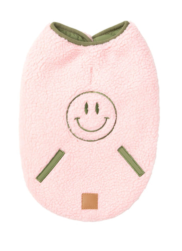 FuzzYard Nara Reversible Dog Jacket in pink sherpa shown flat from the back with embroidered smiley face and contrast olive trim.